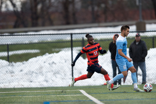 SU senior forward Chris Nanco tracks down a North Carolina defender. The Orange was 17-0 when Nanco scored in a game. He couldn't find the back of the net on Sunday.