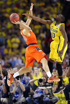 Brandon Triche attempts to force a shot up as Glenn Robinson III attempts a block.