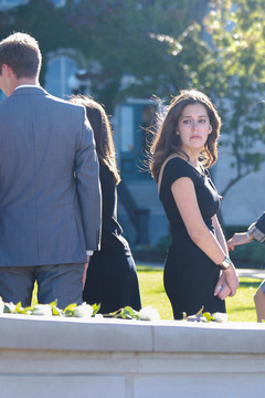 Remembrance Scholar Gabriela Riccardi, a magazine major, looks back at the roses moments before leaving for the convocation ceremony.