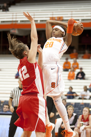 Brittney Sykes cocks back to fire a pass over a Cornell defender. The Syracuse guard scored 23 points, grabbed eight rebounds, dished six assists and came away with five steals.