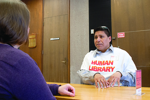 Neal Powless, assistant director of the native student program at SU, tells his story during Wednesday's Human Library event.