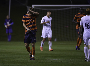 Oyvind Alseth wipes his face during Syracuse's win over Albany. Despite a hectic schedule, head coach Ian McIntyre has been able to rotate his players in and out to keep them fresh.