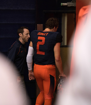 Eric Dungey heads to the locker room in the third quarter of Syracuse's loss to Pittsburgh. He lay motionless on the turf after another hit to the head but later returned to the game.