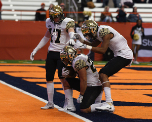 Wake Forest kneels in the end zone of the Carrier Dome.