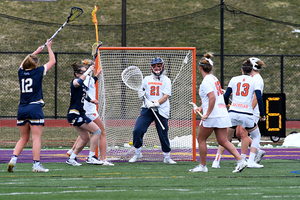 Syracuse players patrol around the net.