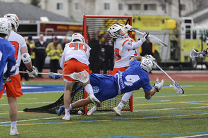 Duke's Jake Seau attempts a crease dive against Syracuse goalie Drake Porter last season.