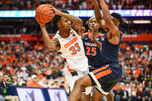 Elijah Hughes gets smothered by two defenders. Hughes had 14 points in the loss.