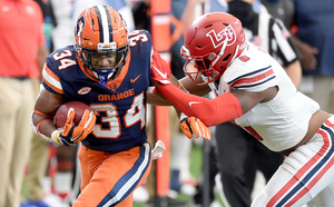 Sean Tucker runs past a Liberty University defender in a 38-21 loss. 