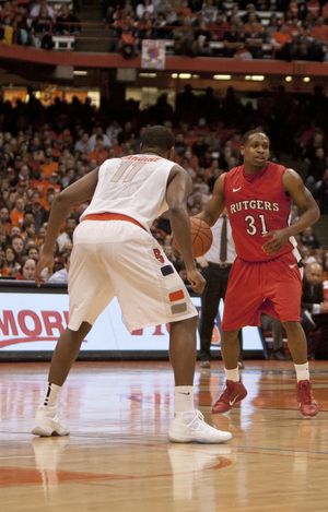 SU's Scoop Jardine (11) defends Rutgers' Mike Coburn. 