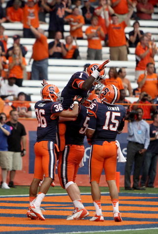 Ashton Broyld (1) celebrates with Chris Clark, Macky MacPherson and Alec Lemon following his first career touchdown.