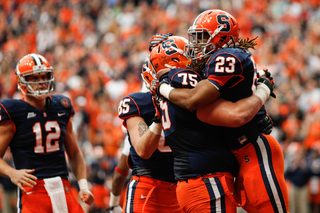 Prince-Tyson Gulley (23) celebrates with Zack Chibane after scoring a touchdown in the first half.