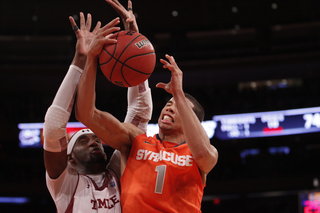 Michael Carter-Williams tries to go up and over Temple's Anthony Lee. Lee had two blocks and played all but two minutes.