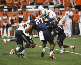 Running back George Morris II and defensive back Darius Kelly converge to block a punt.