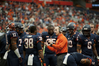 SU linebackers coach Clark Lea instructs his unit on the sideline.