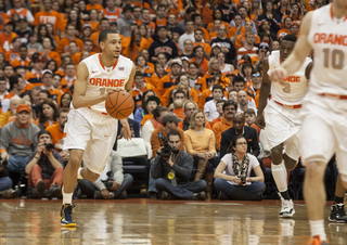 Ennis scans the floor while pushing the ball upcourt. 