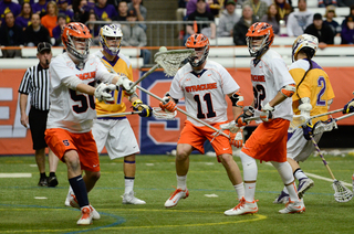 Dominic Lamolinara picks up a loose ball off the ground as teammates look on. 