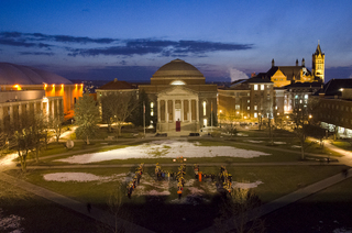 Students gather in front of Hendricks Chapel to pose for a photo for the 144th anniversary of Syracuse University. Notable members in the photo were Otto the Orange and Emmanuel Johnson, better known as “dome dog.”  Set-up for the photo began at 7:45 p.m. and the photo was shot at 8:00 p.m.