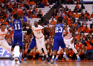 Joseph lunges to contest Deron Powers jump shot. 