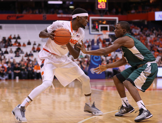 SU sophomore forward B.J. Johnson, who started in place of the injured Tyler Roberson, sizes up a Greyhounds defender on the perimeter.