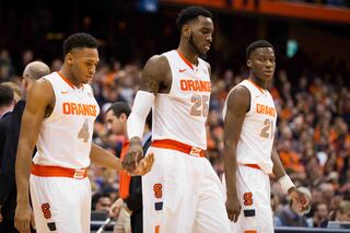 Ron Patterson and Christmas exchange a low-five as Roberson looks on and the trio walks onto the Carrier Dome floor.