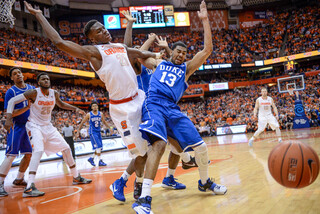 A loose ball gets away from SU forward Tyler Roberson and Duke's Matt Jones. 