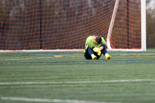 Hilpert sits alone on the field after the game. Allowing just one goal wasn't good enough on Sunday.