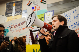 Syracuse area activist, Brian Escobar, addresses the crowd and leads crowd in saying 