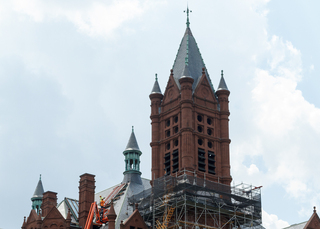 Workers are halfway done with the glass replacement for the Crouse College skylights. The project is expected to be completed by the start of the fall semester. Photo taken Aug. 1, 2017