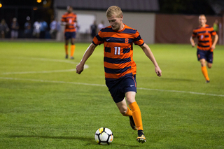 Junior Adnan Bakalovic dribbles the ball late in the game.