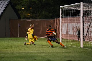 After scoring on his penalty kick, Kamal Miller grabs the ball and runs back toward midfield.