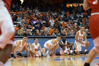 A handful of Syracuse players wait to enter the court. 