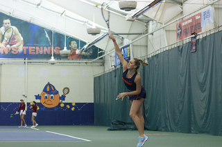 Gabriella Knutson reaches up on a serve.