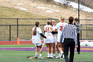 Syracuse players huddle after a score.