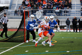 Stephen Rehfuss cradles the ball near the crease. 