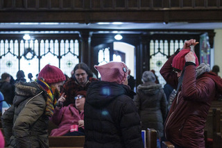 Protesters wear pink hats, a recent emblem of the women's rights movement in the U.S. 