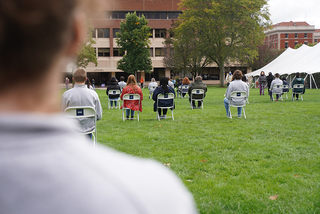 For the 35-minute ceremony, Remembrance Scholars sit in the chairs that the students they represent sat in on their flight back to Syracuse.